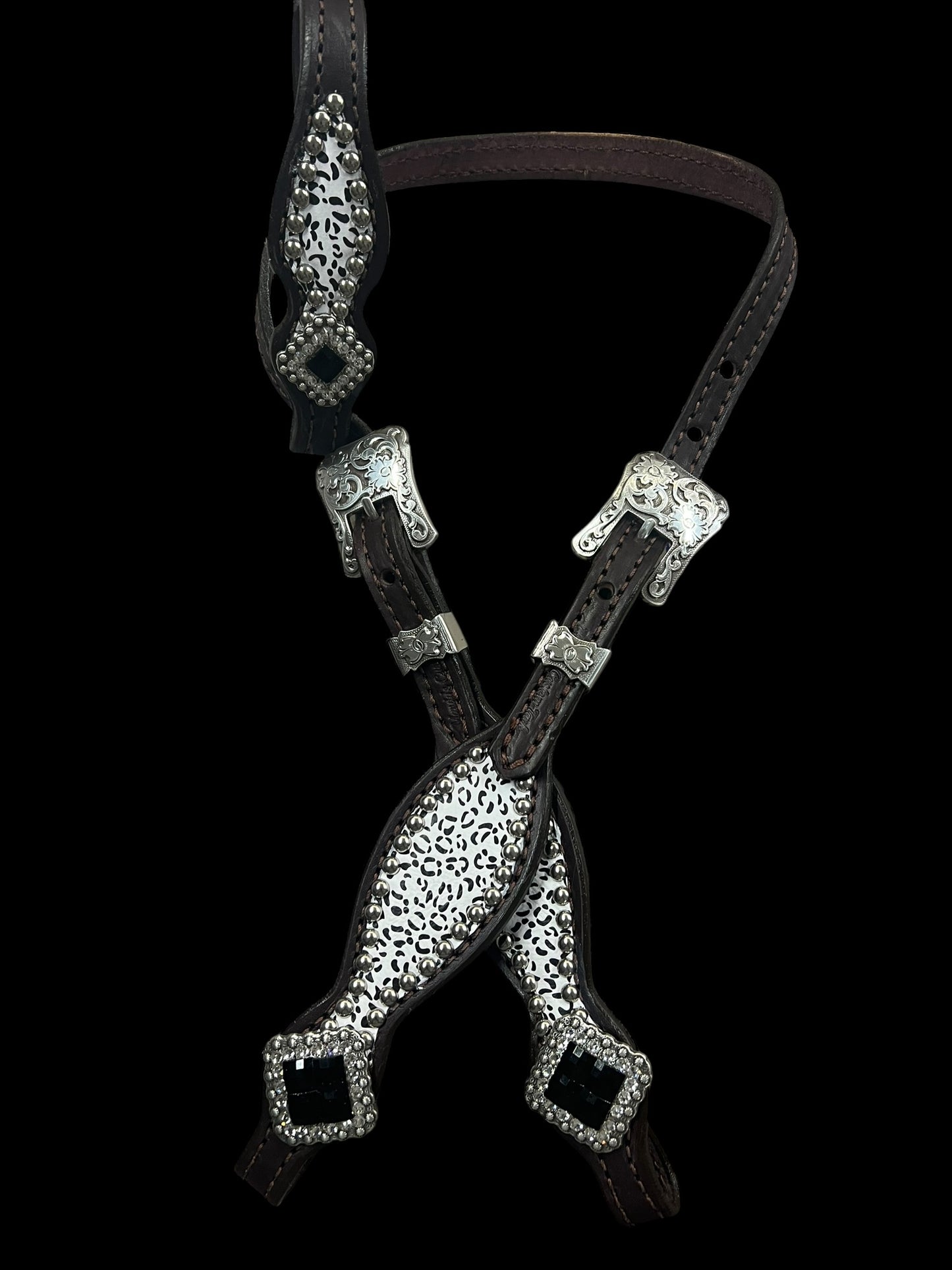Snow leopard on dark leather