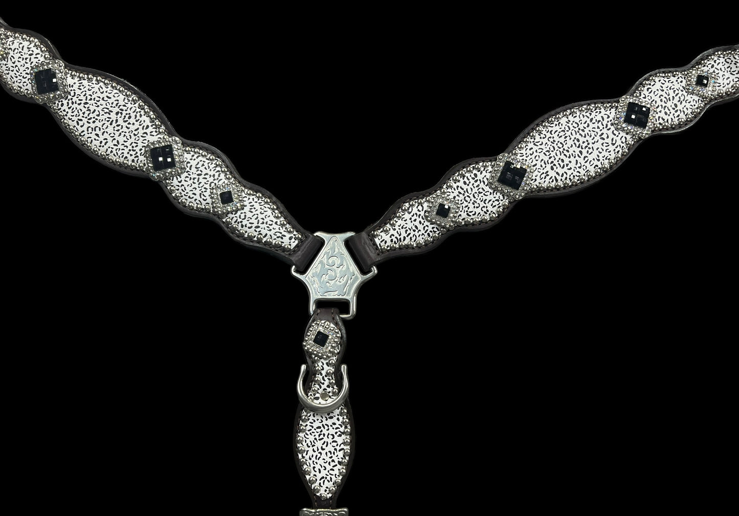 Snow leopard on dark leather