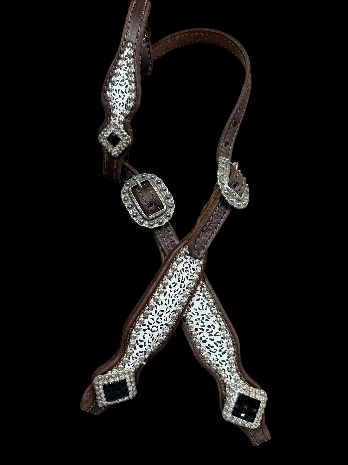 Snow leopard on dark leather