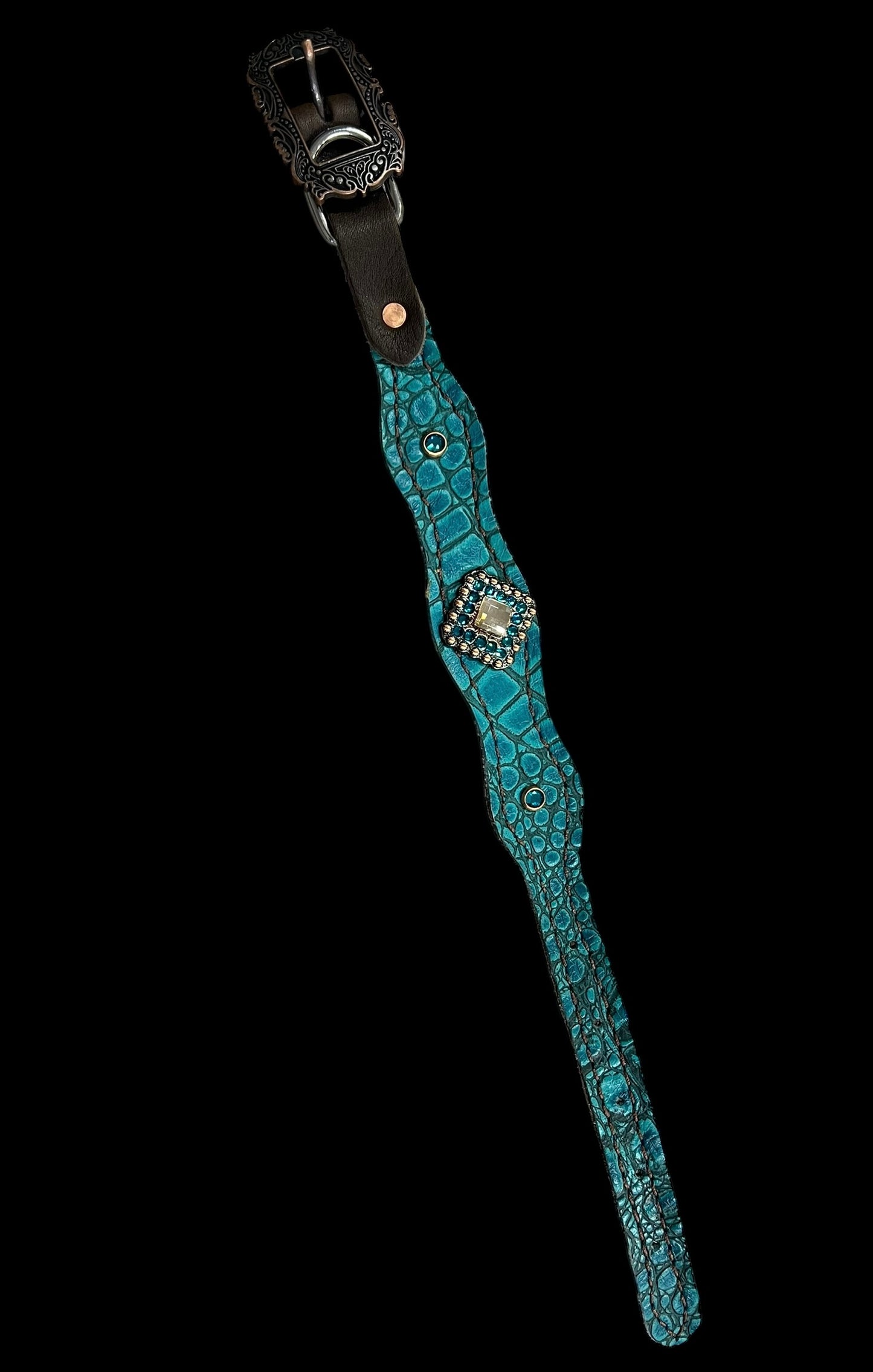 Teal gator on dark leather